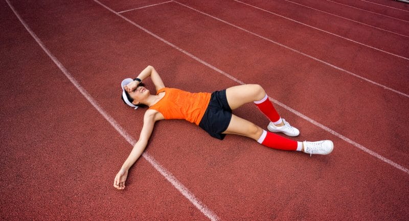 Should you give up on SEO? Not really! Here a person is lying on a track because she has given up